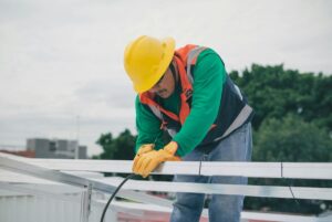 Electrician in Texas Wiring a solar panel on a roofup