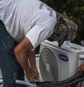 Man fixing an airconditioner in texas