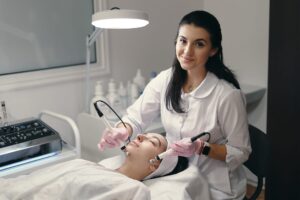 A woman performing a cosmetology procedure on another woman